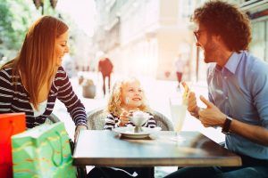Family sitting at table at restaurant in Kelowna