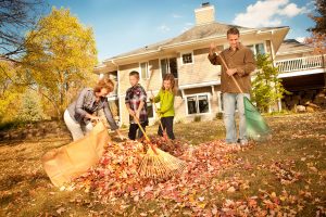 family cleaning front yard of Kelowna real estate