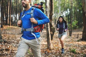 couple hiking through a forest
