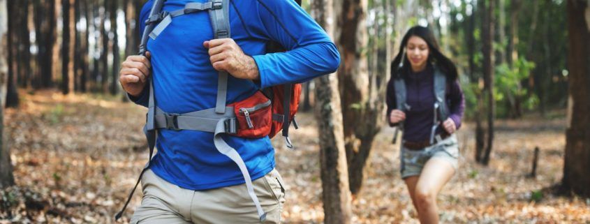 couple hiking through a forest