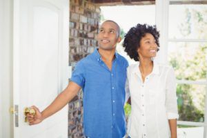 couple walking in door of home 