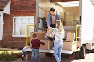 parents and son unloading moving truck