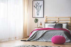 neutral bedroom with a pop of bright pink accents