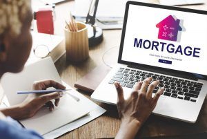 woman sitting at computer looking at mortgage options