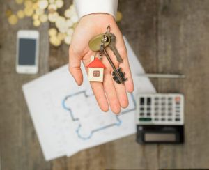 handing over keys to your Kelowna real estate