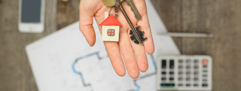 handing over keys to your Kelowna real estate