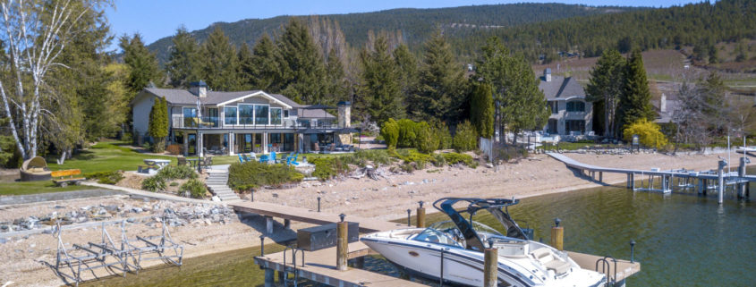 okanagan waterfront property with deck and boat