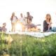 group of friends relaxing in the grass in a park
