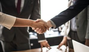 realtor shaking hands with client after purchase