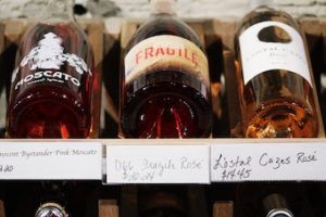 bottles of rose wine on shelf 