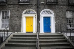 Yellow and blue door on brick house