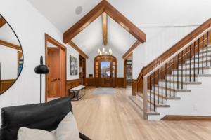 Beautiful foyer with wooden ceiling beams and a grand staircase