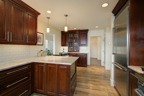 Cherry oak kitchen with a large stainless steel fridge, granite countertops in 2650 Lakeview