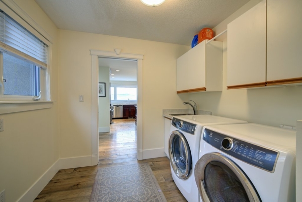 Spacious laundry/mudroom with washer and dryer plus extra storage and sink in 2650 Lakeview
